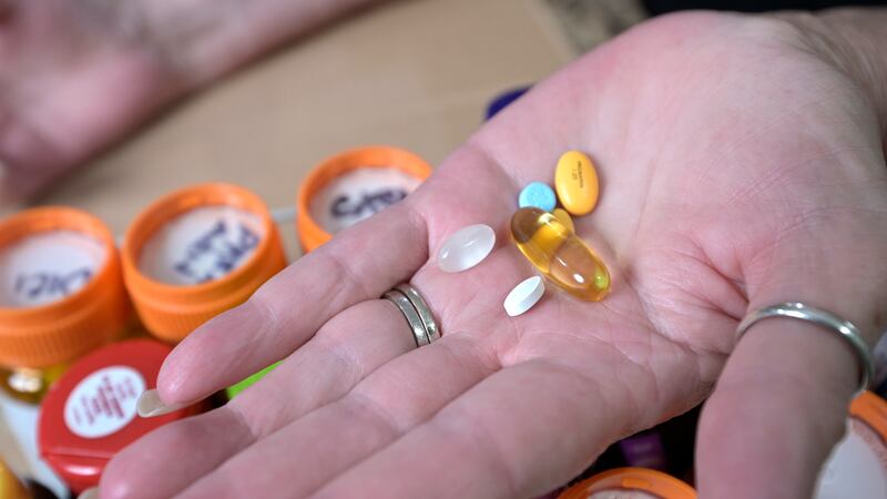 FILE - Retiree Donna Weiner shows some of the daily prescription medications that she needs...