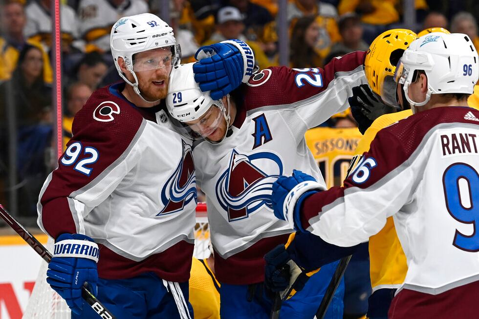 Colorado Avalanche center Nathan MacKinnon (29) celebrates with left wing Gabriel Landeskog...
