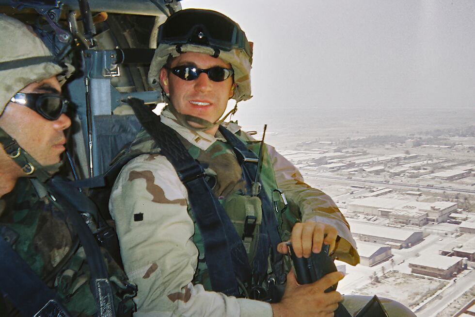 In this image provided by Rep. Jason Crow, Army Lt. Jason Crow sits in a helicopter as he...