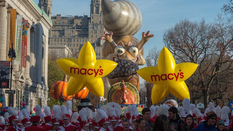 Performers stand in front of balloons at the start of the Macy's Thanksgiving Day Parade,...
