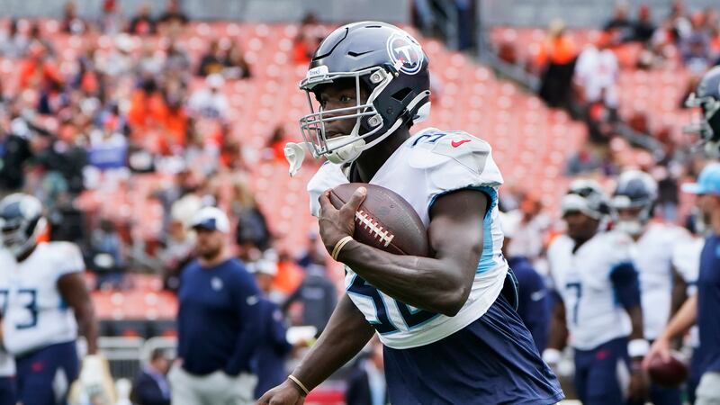 Tennessee Titans running back Tyjae Spears warms up before an NFL football game against the...